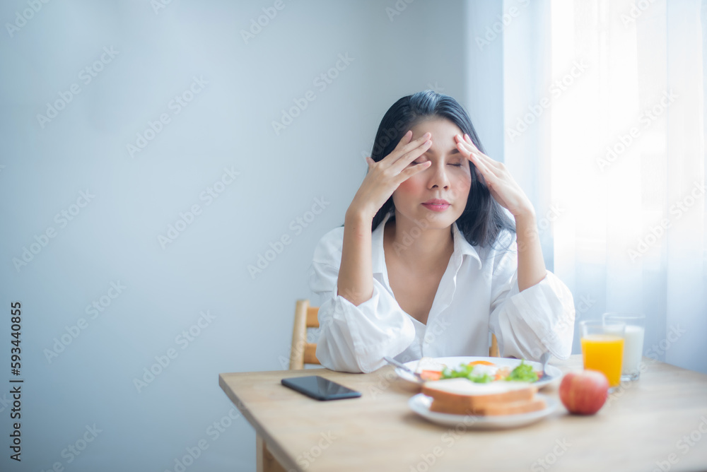 Beautiful asian girl's breakfast had become a source of frustration rather than a source of nourishment.