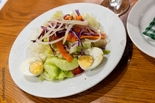Appetizing salad with egg, carrots, onions and lettuce. Spanish dish