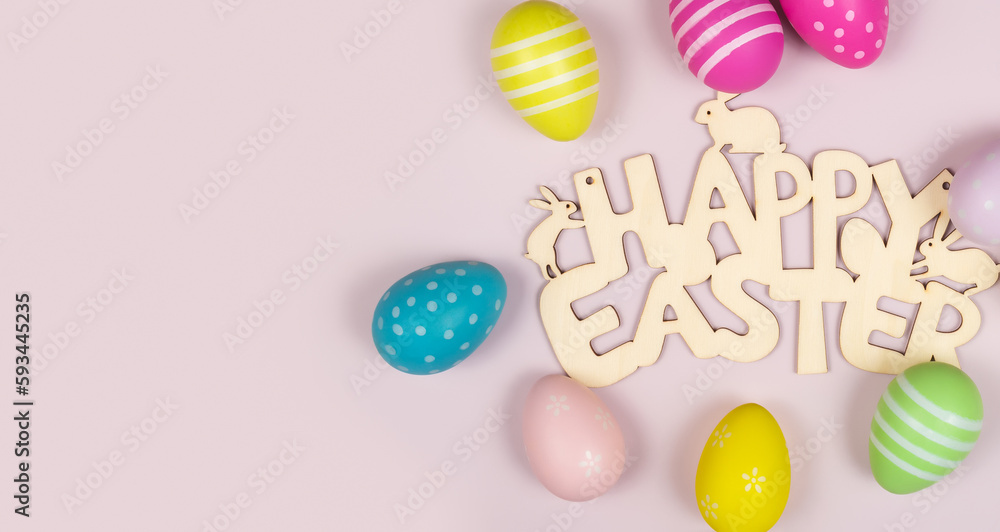 greeting card with text happy easter. multicolored easter eggs on pink background