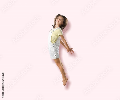 Excited child student jump on pink background