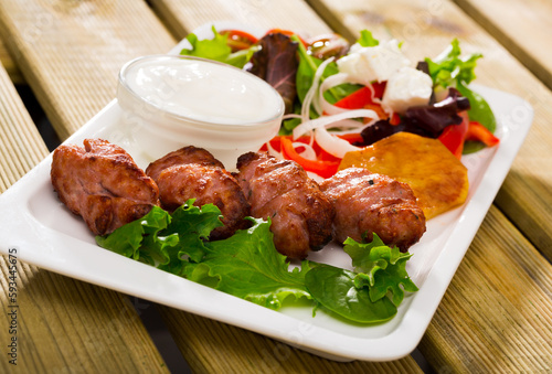 National Bulgarian dish Kebapcheta (grilled sausages) served with salad and green cheese