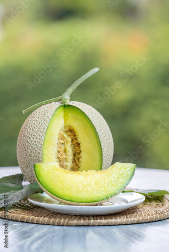 Фотография Crown Musk Melon on nature background, Shizuoka Crown Melon Yama Grade on Green bokeh background