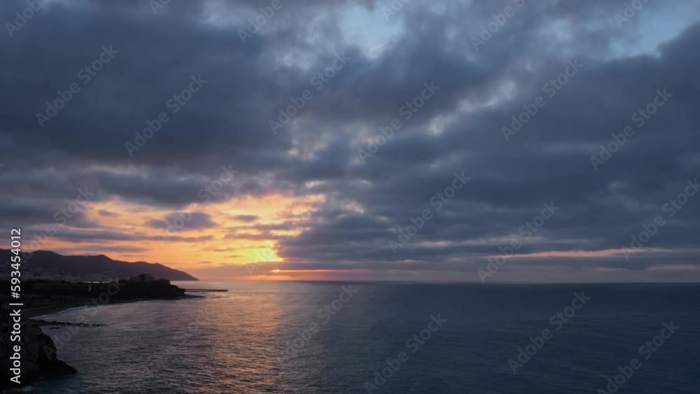 Experience magic of a golden hour time-lapse capturing serene sunrise over a calm sea near a beautiful rocky coastline Experience magic of a golden hour time-lapse capturing serene sunrise over a calm sea near a beautiful rocky coastline