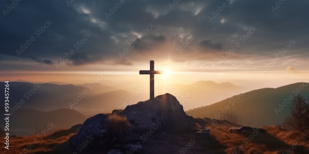 A Cross Silhouetted Against a Colorful Mountain Sunset