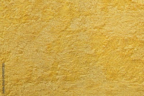 Texture of a yellow terry fabric as an abstract background photo