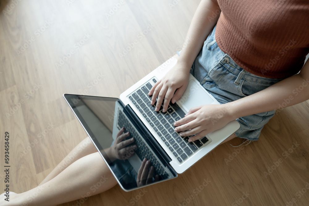 Fototapeta premium Woman Working by using laptop blank screen computer . Hands typing on a keyboard.technology e-commerce concept.