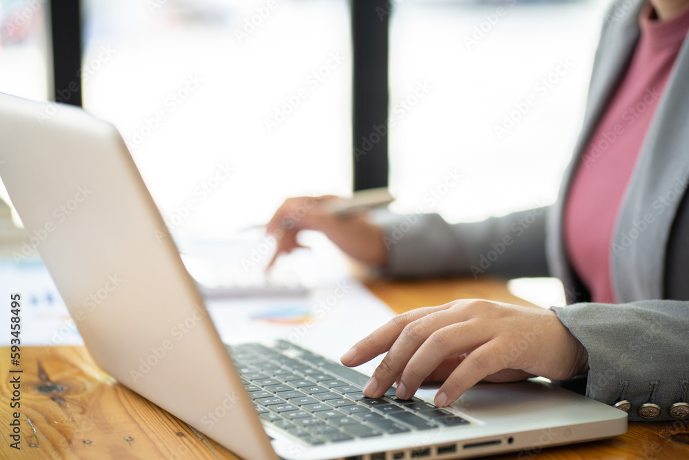 Business Woman working by using laptop computer Hands typing on a keyboard. Professional investor working new start up project. business planning in office. Technology business Concept Business Woman working by using laptop computer Hands typing on a keyboard. Professional investor working new start up project. business planning in office. Technology business Concept
