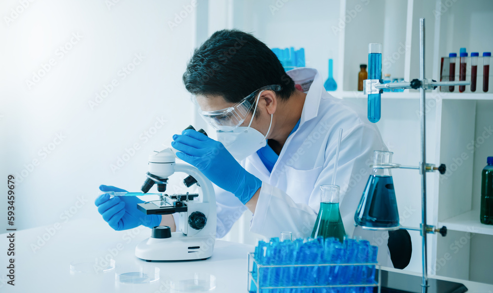 Male scientist researcher conducting an experiment working in chemical laboratory Male scientist researcher conducting an experiment working in chemical laboratory