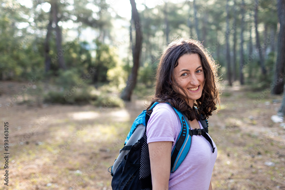 Happy smiling woman.Hiking in the mountains. Young woman tourist smiling, sports and trekking in nature. Happy smiling woman.Hiking in the mountains. Young woman tourist smiling, sports and trekking in nature.