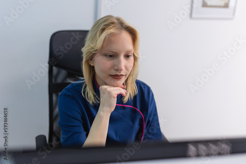 Woman doctor in uniform work with document in private clinic. Nurse sitting behind desk in office, checking medical history or anamnesis of client, reading patient treatment plan