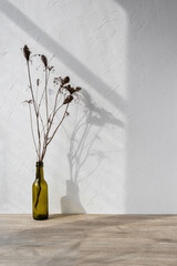 Minimalist template for home room interior product, vase with flowers on beige wooden table or floor, aesthetic sunlight shadows on white wall, background for branding design showcase, copy space