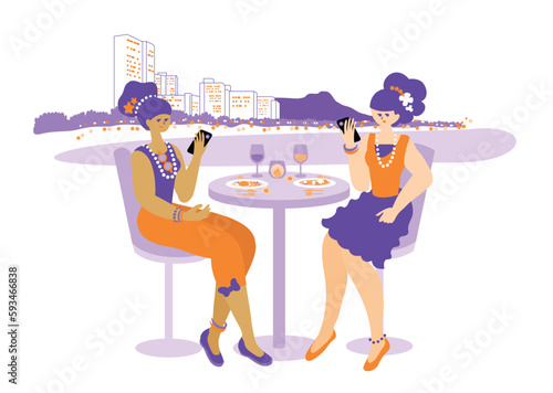 Women enjoying food on the terrace of a restaurant while traveling