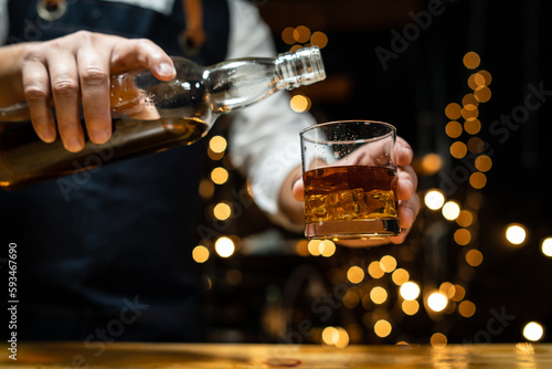 Barman pouring beer glass beautiful night