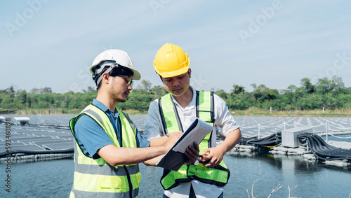 Team of engineers wearing a uniform inspect and check solar cell panel, solar cell is smart ecology energy sunlight alternative power factory concept. © Nabodin