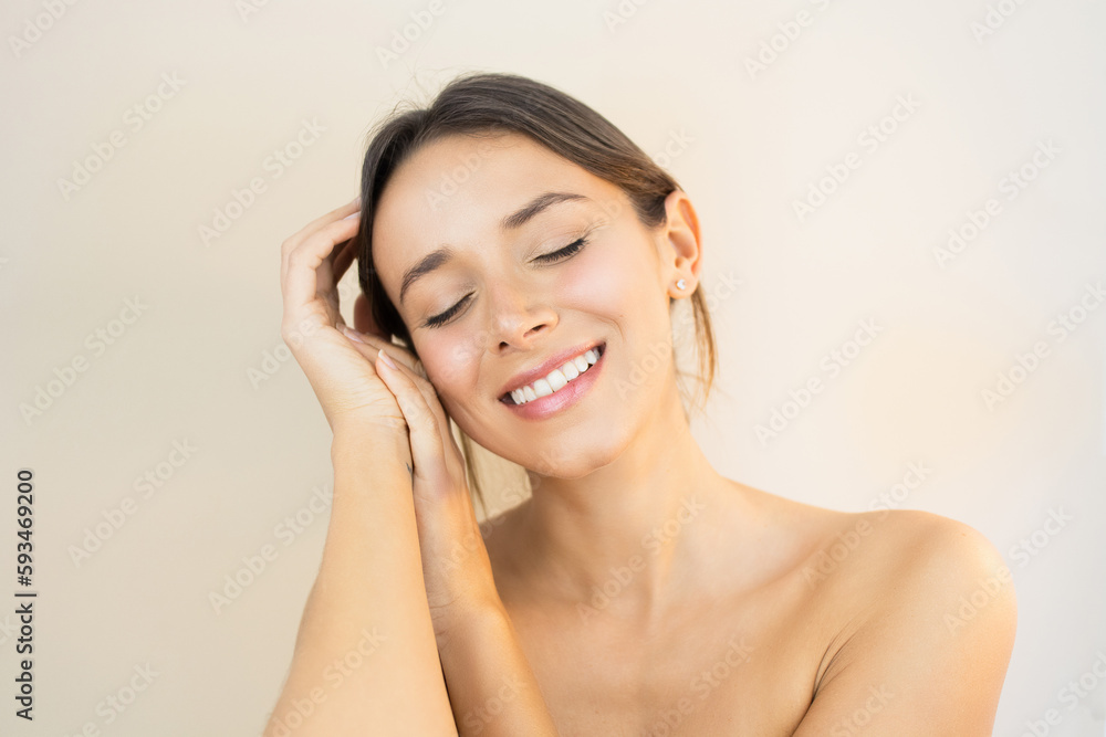 Young Woman With Glowy Skin Eyes Closed Touching her Face with Flawless Healthy and Bright No-Makeup Makeup Look