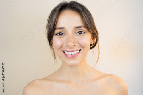 Happy Young Woman With Bright, Glowy and Healthy Skin Smiling Looking at You Feeling Happy and Relaxed