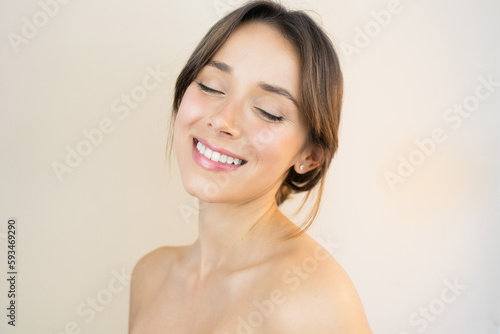 Happy Young Woman With Bright, Glowy and Healthy Skin Smiling with Eyes Closed Feeling Happy and Relaxed