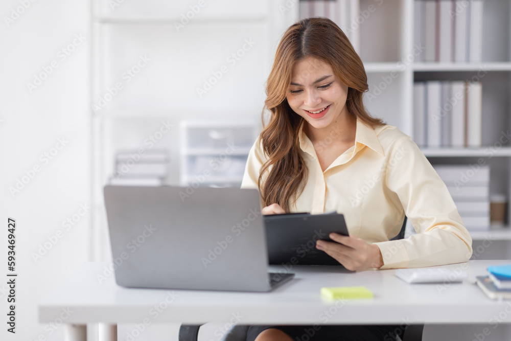Asian Business woman using calculator and laptop for doing math finance on an office desk, tax, report, accounting, statistics, and analytical research concept
Asian Business woman using calculator and laptop for doing math finance on an office desk, tax, report, accounting, statistics, and analytical research concept