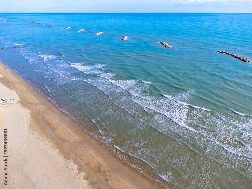 Aerial view landscape Italy Pescara. Sea, waves, breakwater, stones, rocks, beach, sand, empty.
