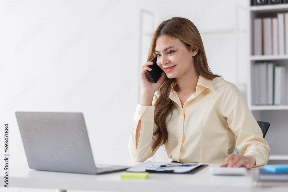 Cheerful business Asian woman freelancer making telephone call share good news about project working in office workplace, business finance concept. Cheerful business Asian woman freelancer making telephone call share good news about project working in office workplace, business finance concept.