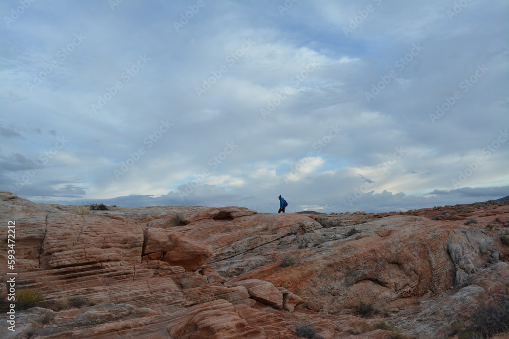 beautiful scenery of red sandstone, a man hiking Valley of Fire State Park in Nevada, USA beautiful scenery of red sandstone, a man hiking Valley of Fire State Park in Nevada, USA