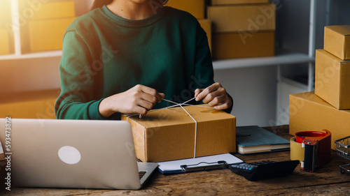 Business woman start up small business entrepreneur SME success .freelance woman working at home with Online Parcel delivery. SME and packaging deliveryconcept © ARMMY PICCA