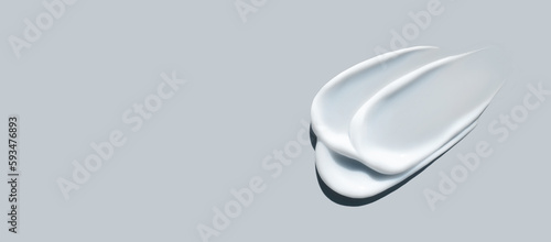 Fotografie cosmetic smears of creamy texture on gray background