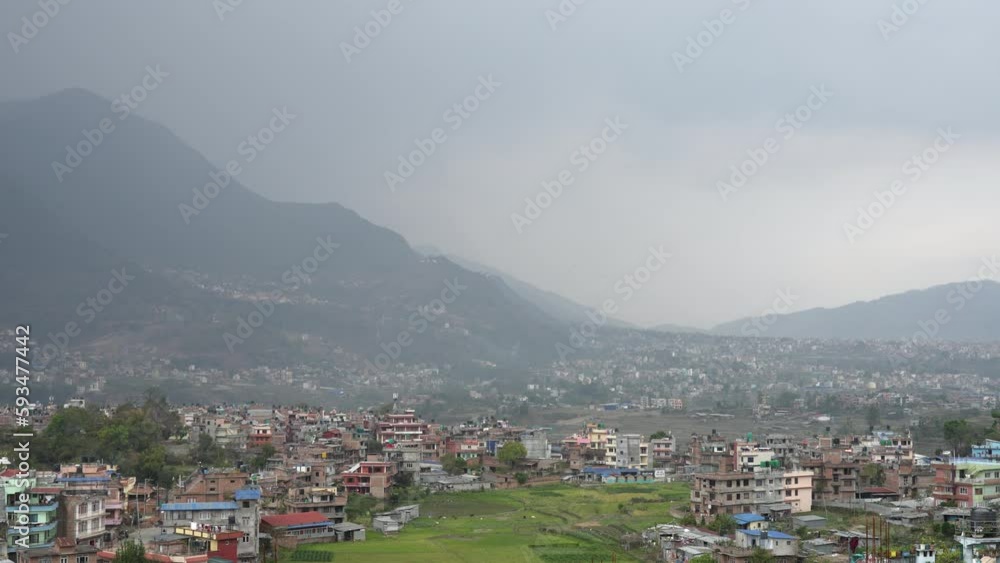 A panning view of the mountains surrounding a small city nestled in the Himalaya Foothills of Nepal. A panning view of the mountains surrounding a small city nestled in the Himalaya Foothills of Nepal.