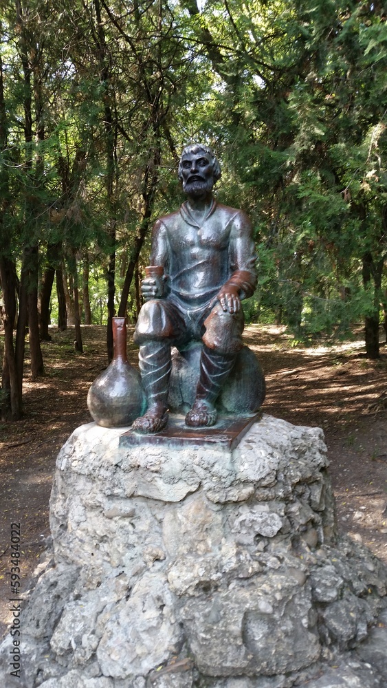 The sculpture "A Man with a Jug" by the Polish sculptor Ludwig Karol Szodki was installed on the Vorontsovskaya Alley of the Yessentuki Resort Park in 1903. - obrazy, fototapety, plakaty 