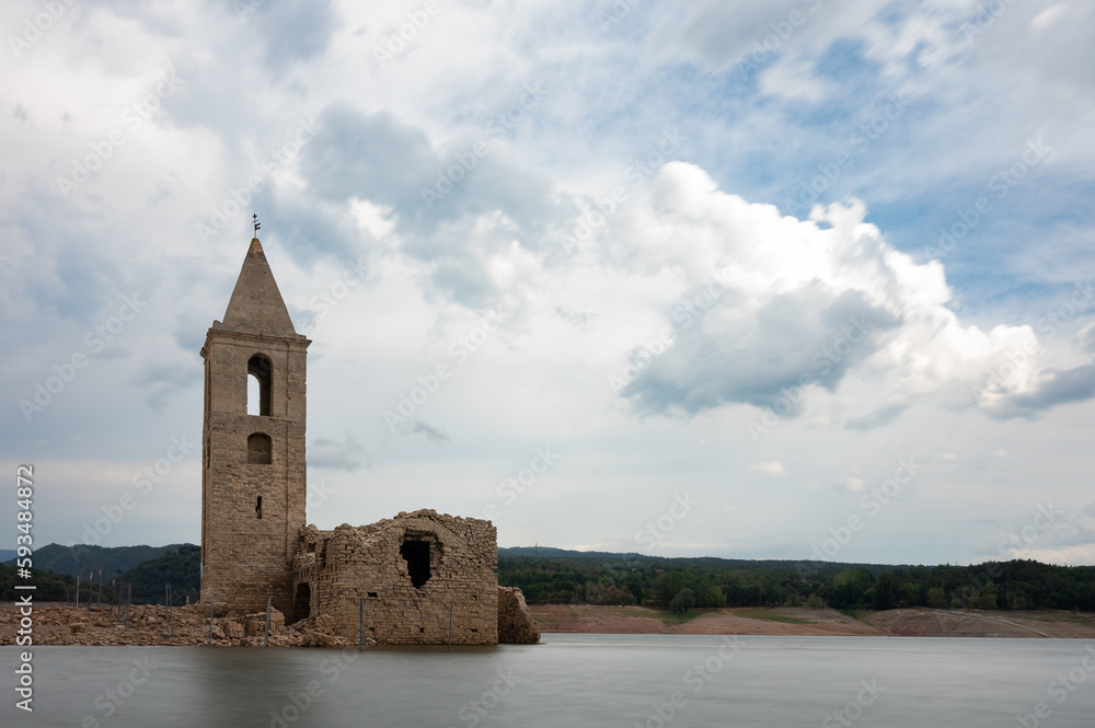 Long exposure photography of the Church of Sant Roma de Sau in the Sau reservoir with silk effect water without people