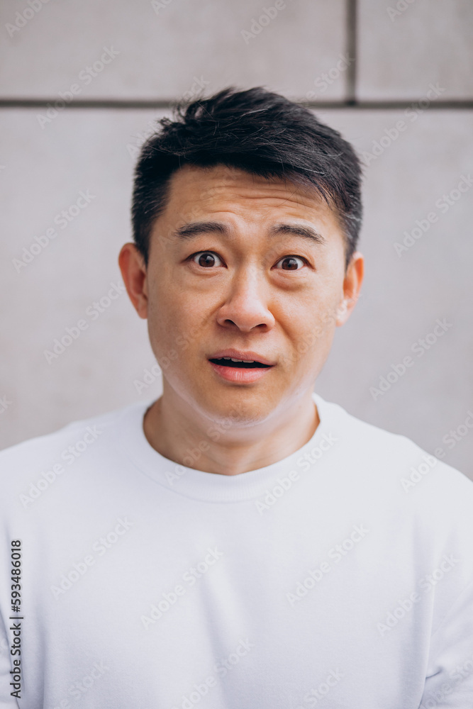 Asian man isolated expressing emotions Asian man isolated expressing emotions
