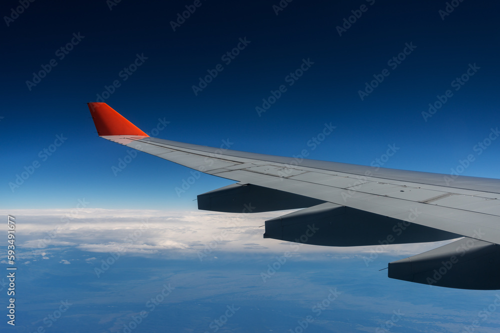 Fototapeta premium Wing of a airplane at sunrise at an altitude of 11 km.