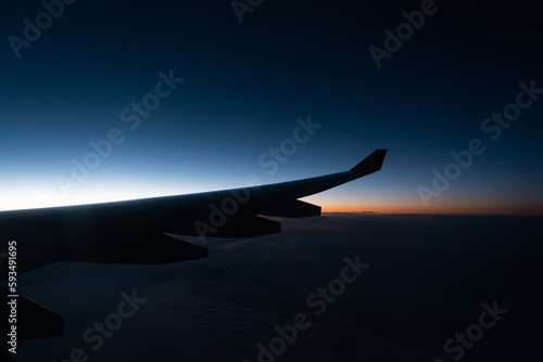 Wing of a airplane at sunrise at an altitude of 11 km.