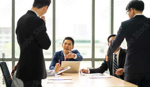 Group of asian business meeting and discussing strategy startup project analysis finance process.Success asian business people work plan and brainstorm marketing idea with laptop in office.Teamwork