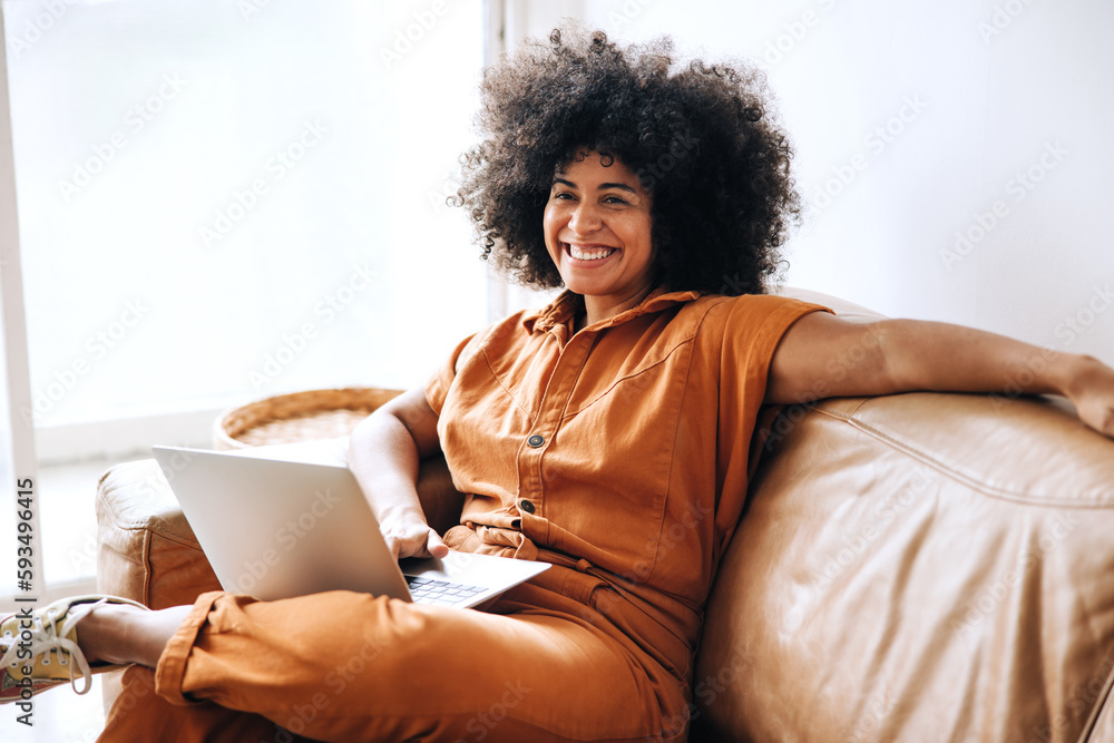 Cheerful young businesswoman smiling while sitting on a couch Cheerful young businesswoman smiling while sitting on a couch
