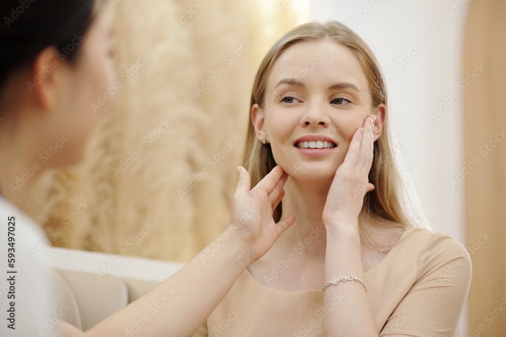 Young woman visiting esthetician to get skicare treatment Young woman visiting esthetician to get skicare treatment