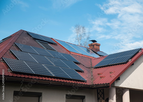panele fotowoltaiczne oraz solarne zamontowane na jednym dachu domu jednorodzinnego photo
