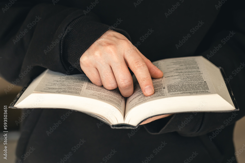 Open book Bible in male hands, close-up. Open book Bible in male hands, close-up.