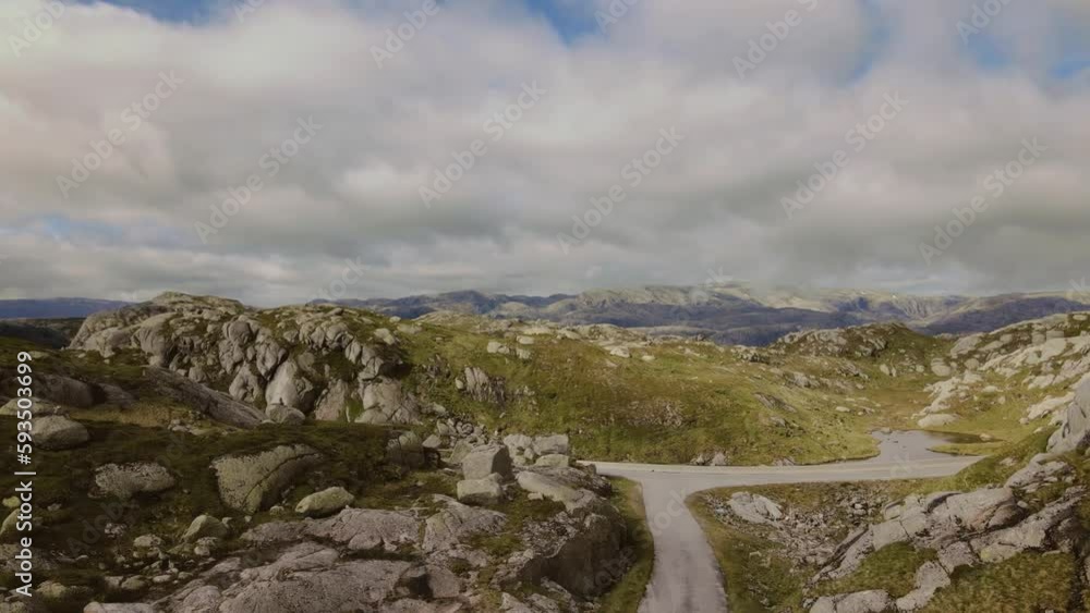Ascending aerial view of epic landscape moving slowly while floating above glacial lakes and mountain hills. Drone shot near Lysebotn, Norway Ascending aerial view of epic landscape moving slowly while floating above glacial lakes and mountain hills. Drone shot near Lysebotn, Norway