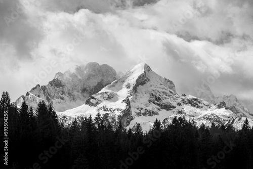 Monochrome panoramic view on the bavarian alps with snowy Alpspitze and Hochblassen ranges on a cloudy day close to Garmisch photo