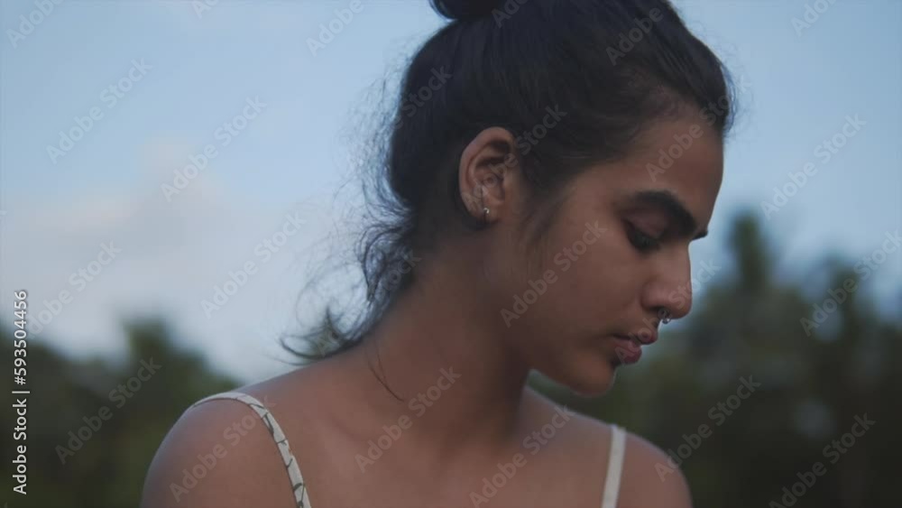 The portrait of a stressed young Indian woman, unable to make a choice in a difficult situation. Teen Asian female suffering with depressed appearance due to planet destruction The portrait of a stressed young Indian woman, unable to make a choice in a difficult situation. Teen Asian female suffering with depressed appearance due to planet destruction