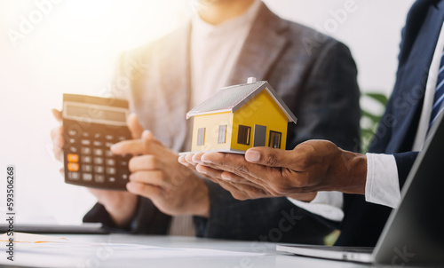 Female woman hands holding home model, small miniature white toy house. Mortgage property insurance dream moving home and real estate concept photo