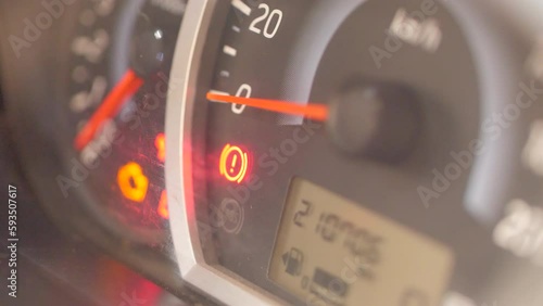 Old car showing engine handbrake signal on the car dash board