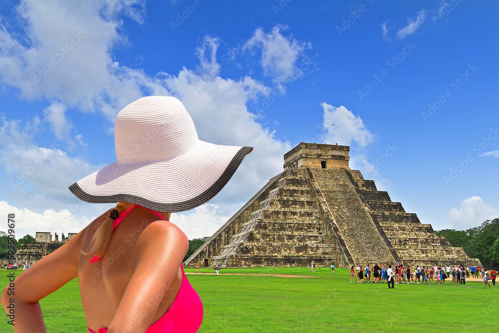 Woman in hat enjoying holidays at Kukulkan pyramid in Chichen Itza, Mexico.
