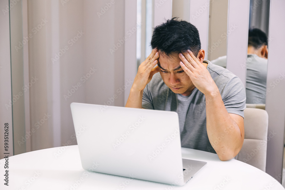 Stressed tired man in pain having strong terrible headache attack after computer laptop work, fatigued exhausted guy suffering from chronic migraine massaging temples to relieve head ache tension Stressed tired man in pain having strong terrible headache attack after computer laptop work, fatigued exhausted guy suffering from chronic migraine massaging temples to relieve head ache tension