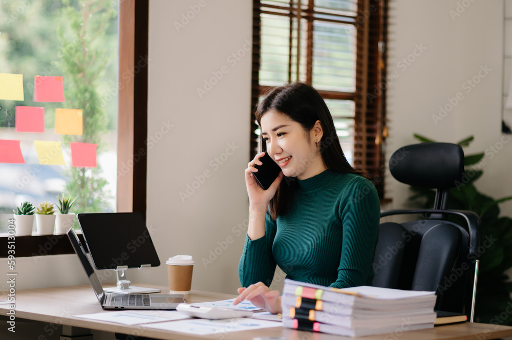 Happy asian business woman have the joy of talking on the smartphone, tablet and laptopon the modern office . Happy asian business woman have the joy of talking on the smartphone, tablet and laptopon the modern office .