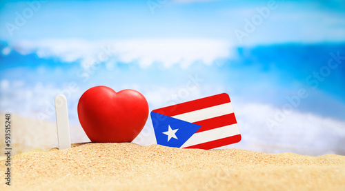 Fototapeta Naklejka Na Ścianę i Meble -  I love Puerto Rico. Flag of Puerto Rico on the beach with a red heart. vacation and travel concept.