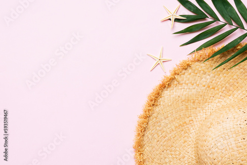 Summer holidays. Summer concept with straw hat and tropical leaf. Flat lay, top view, copy space