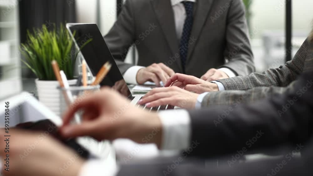 Business professionals working together at office desk, analyzing financial statistics displayed on the laptop screen. Business professionals working together at office desk, analyzing financial statistics displayed on the laptop screen.