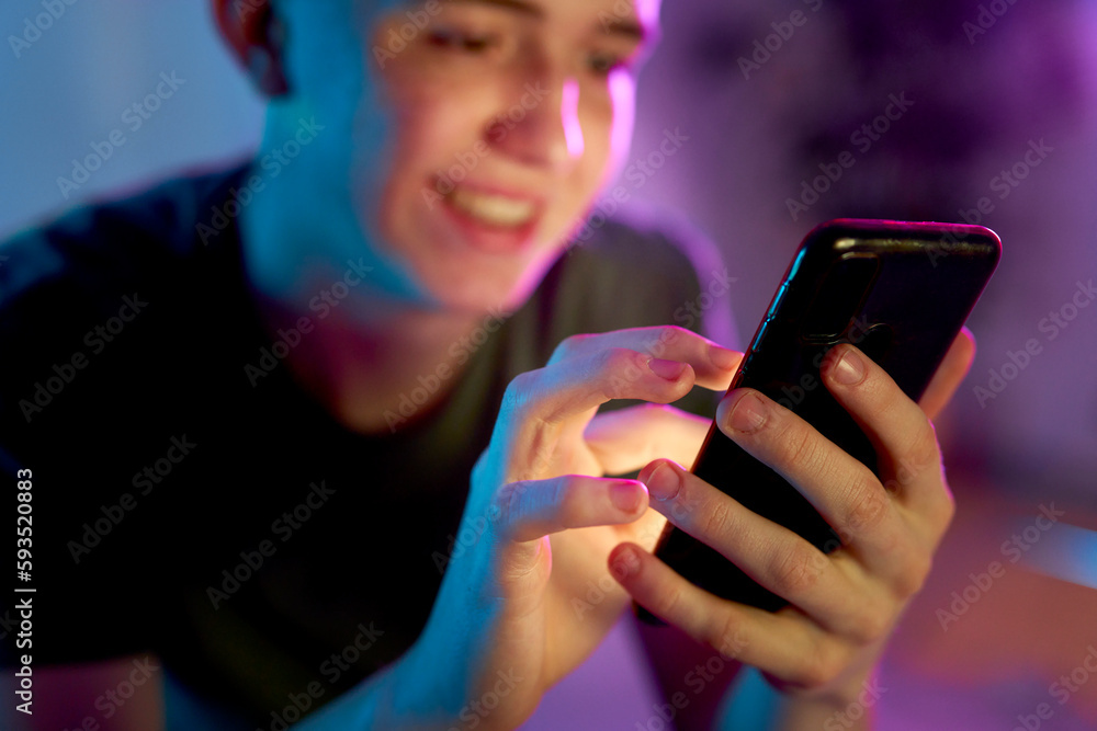 Smiling young man using smart phone Smiling young man using smart phone